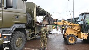 <p> Soldiers from 1 Brigade Signals at a Cork County Council depot filling and delivering sandbags to protect against further flooding in Midleton on October 20, 2023. Picture: Larry Cummins</p>