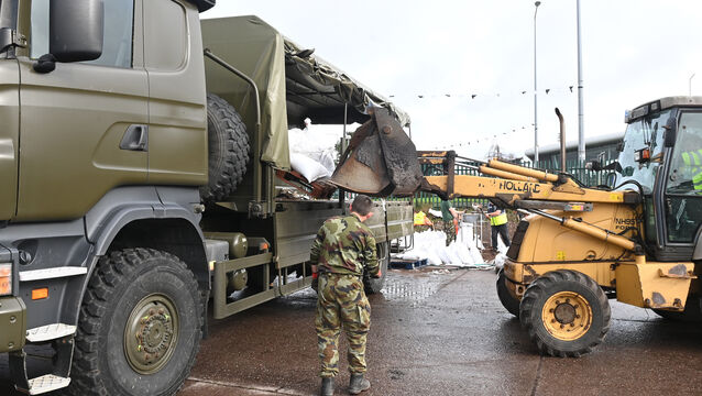 <p> Soldiers from 1 Brigade Signals at a Cork County Council depot filling and delivering sandbags to protect against further flooding in Midleton on October 20, 2023. Picture: Larry Cummins</p>