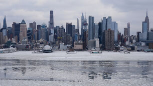 <p>Ice floats on the Hudson River as New York experienced its snowiest day in years (Seth Wenig/AP)</p>