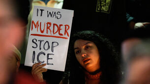 <p>A demonstrator holds a sign during a candlelight vigil during a protest in response to the fatal shooting of 37-year-old Alex Pretti in Minneapolis. Picture: AP Photo/Caroline Brehman.</p>
