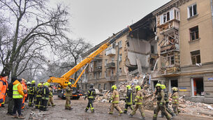 Rescue workers clear the rubble of a residential building which was damaged after a Russian strike in Odesa (Michael Shtekel/AP)