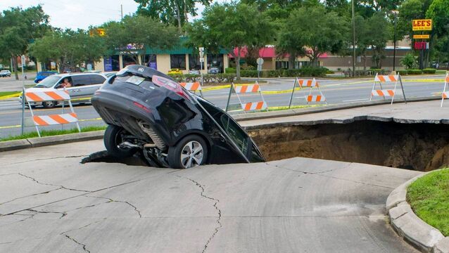 <p>A large sinkhole opens in a parking area in Ocala, Florida, and swallows a car that teeters on the edge. File picture: June 11, 2017</p>