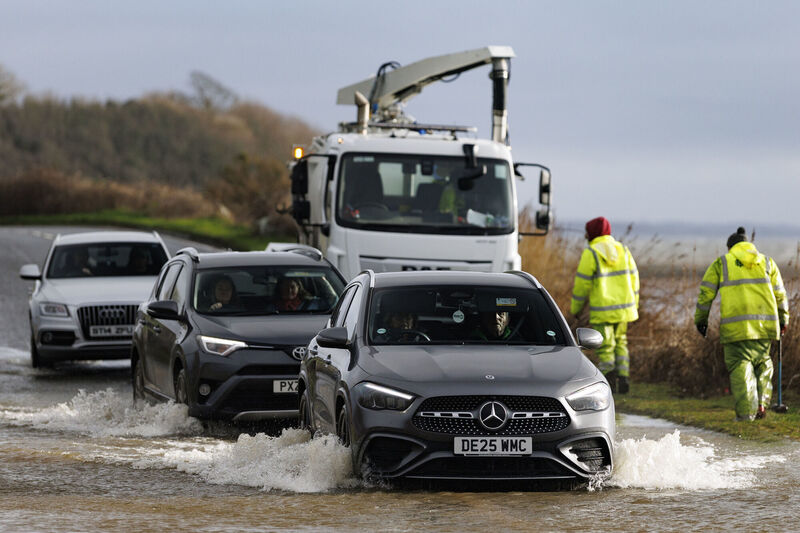 Vehicles pass through a flooded area of the Portaferry Road in Newtownards. Picture Liam McBurney/PA Wire