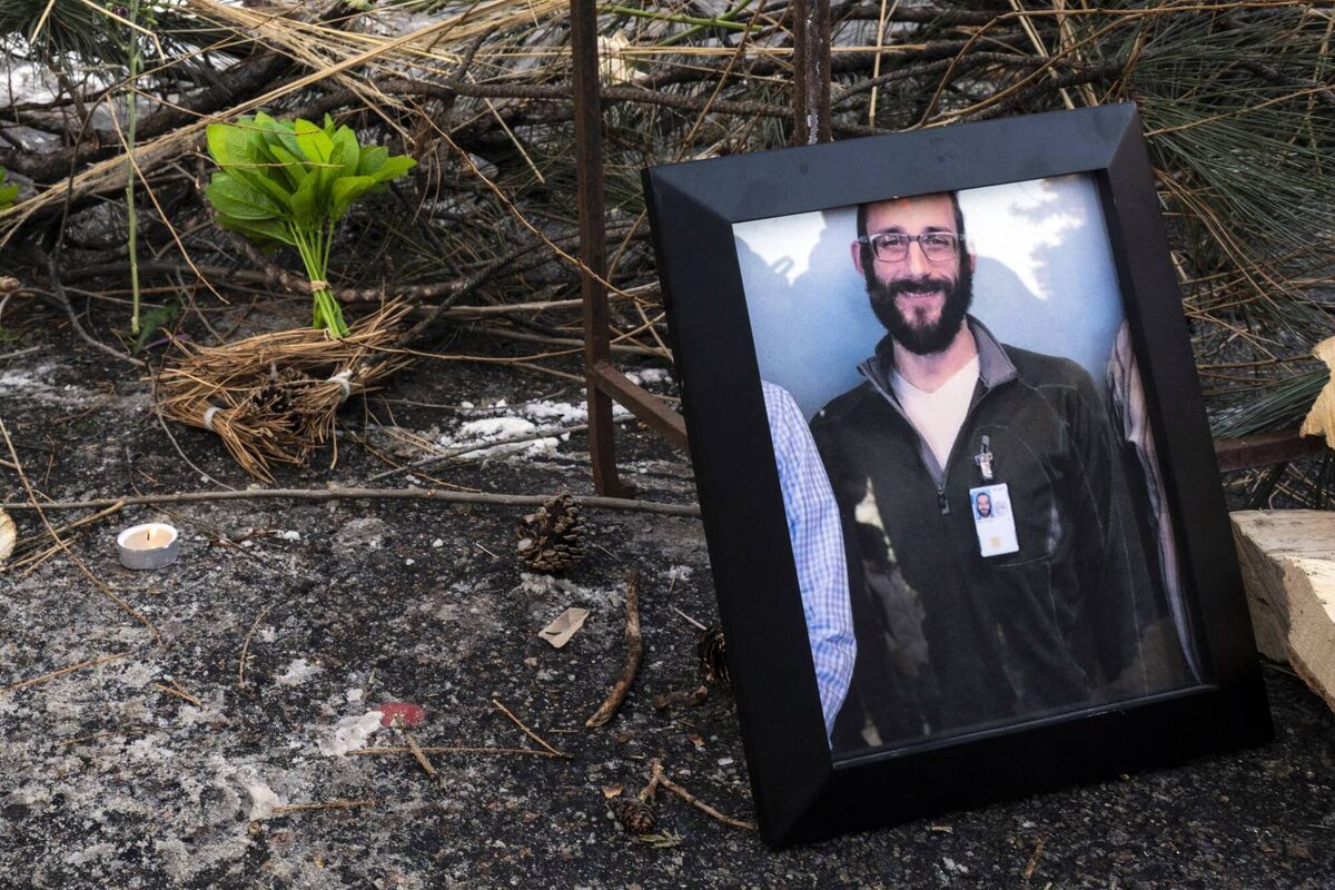 A photograph of 37-year-old Alex Pretti can be seen at a makeshift memorial in the area where he was shot dead by federal immigration agents earlier in the day in Minneapolis, Minnesota, on January 24, 2026. Picture: ROBERTO SCHMIDT / AFP via Getty Images