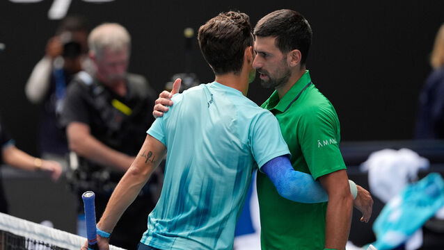 <p>Novak Djokovic, right, embraces Lorenzo Musetti after the Italian was forced to retire from their Australian Open quarter-final. Pic: Asanka Brendon Ratnayake/AP</p>