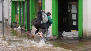 <p>People walking through floodwater in Enniscorthy, Co Wexford. Picture: Niall Carson/PA Wire</p> <p>People walking through floodwater in Enniscorthy, Co Wexford. Picture: Niall Carson/PA Wire</p>