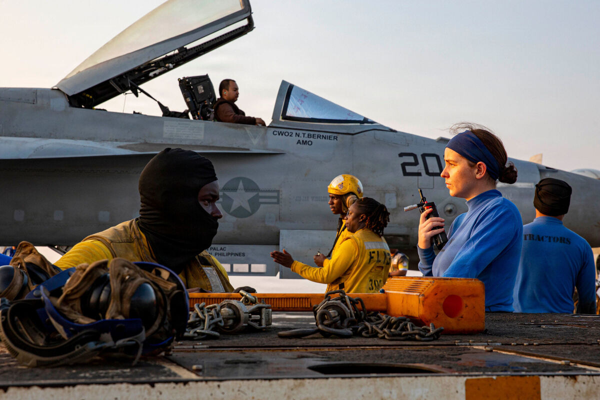 This handout photograph from the U.S. Navy shows sailors taxiing an F/A-18E Super Hornet on the flight deck of the Nimitz-class aircraft carrier USS Abraham Lincoln in the Indian Ocean. Picture: Communication Specialist 3rd Class Shepard Fosdyke-Jackson/U.S. Navy via AP