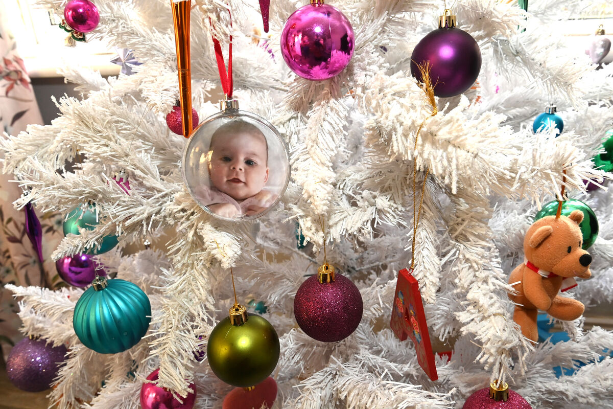 A Christmas decoration containing a photo of a smiling baby Alice on the Christmas tree in their home. Picture: Larry Cummins A Christmas decoration containing a photo of a smiling baby Alice on the Christmas tree in their home. Picture: Larry Cummins