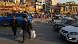 People walk in Tajrish Square in northern Tehran (Vahid Salemi/AP)