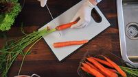Food Safety - Cutting Carrots on Plastic Cutting Board with Food Gloves