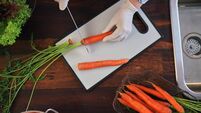 Food Safety - Cutting Carrots on Plastic Cutting Board with Food Gloves