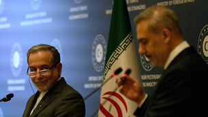 Iranian Foreign Minister Abbas Araghchi, left, looks at his Turkish counterpart Hakan Fidan during a joint press conference in Istanbul (Khalil Hamra/AP)