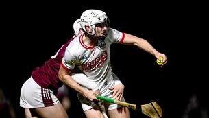 <p>Eoin Roche of Cork is tackled by Colm Molloy of Galway. Pic: Ben McShane/Sportsfile</p>