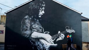 <p>TASTE: Fans arrive for the game between Donegal and Kerry past a Rory Gallagher mural</p>