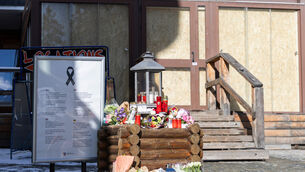 Flower tributes have been left at the entrance to the Le Constellation bar when the fire took place during new year celebrations (Cyril Zingaro/Keystone/AP)