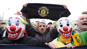 <p>Manchester United fans wore clown masks holding banners during the pre-match protest. Pic: Peter Byrne/PA</p>