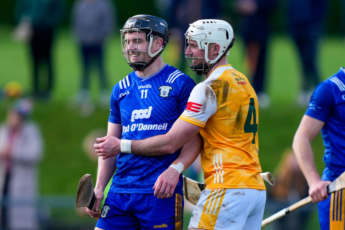 Tony Kelly of Clare with Paddy Burke of Antrim. Pic: ©INPHO/James Lawlor