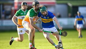 <p>Darragh Stakelum of Tipperary holds off Ben Conneely of Offaly at Glenisk O'Connor Park in Tullamore. Pic: Matt Browne/Sportsfile</p>