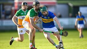 <p>Darragh Stakelum of Tipperary holds off Ben Conneely of Offaly at Glenisk O'Connor Park in Tullamore. Pic: Matt Browne/Sportsfile</p>