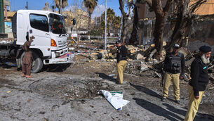 Police officers examine the site of a suicide bombing in Quetta on Saturday (Arshad Butt/AP)