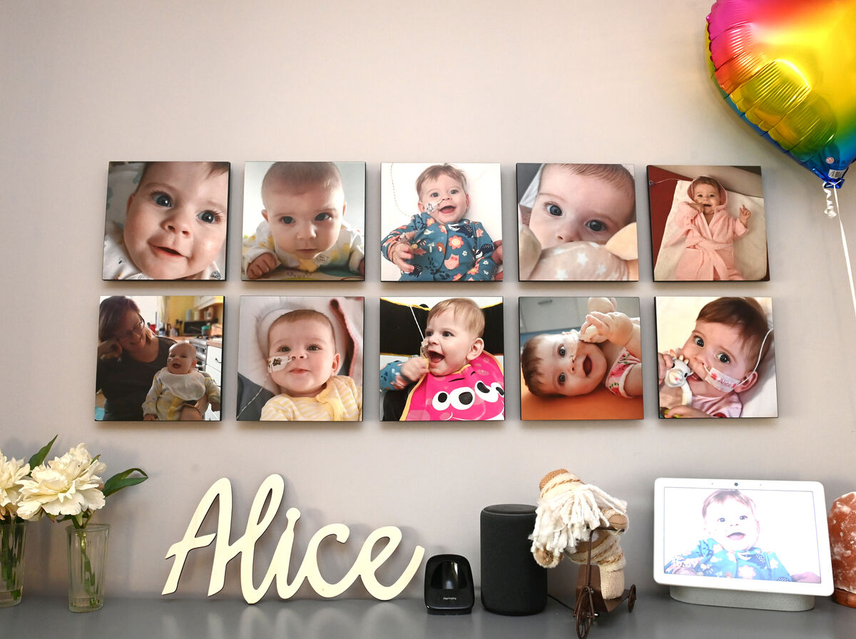 Baby Alice Spang died at just 10 months old due to a heart defect. Pictured is a spread of photos in the family home of a smiling baby Alice marking her short life. Picture: Larry Cummins