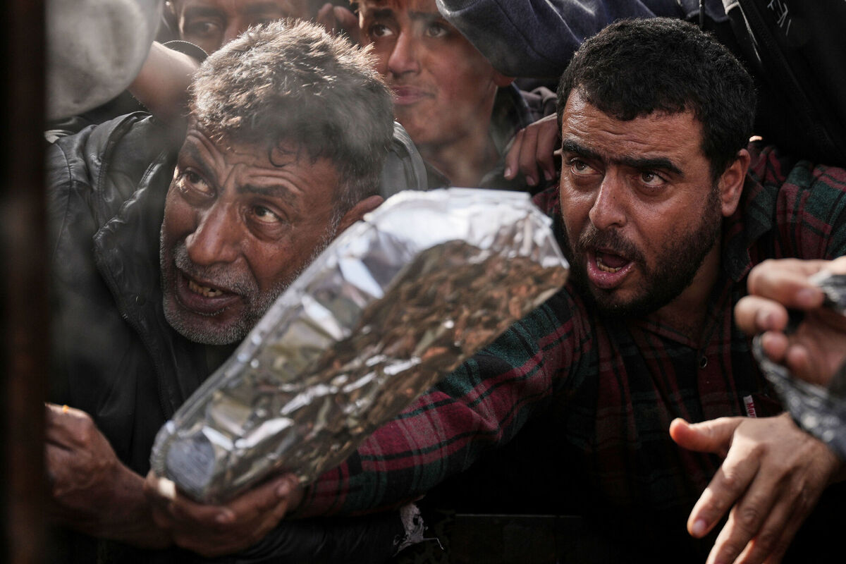 Palestinians wait to receive donated food at a distribution center in Khan Younis, southern Gaza Strip, Friday, Jan 23, 2026. Picture: AP Photo/Abdel Kareem Hana