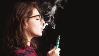 woman smoking electronic cigarette