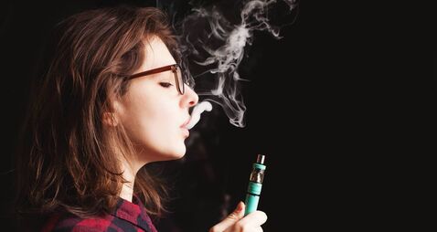 woman smoking electronic cigarette