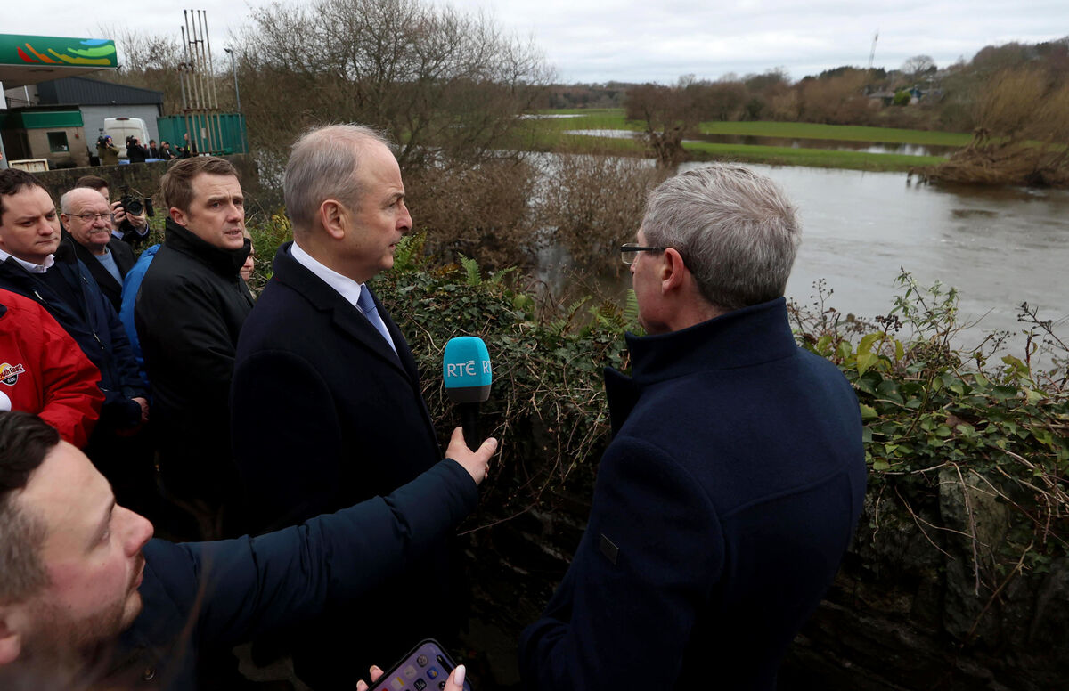 Taoiseach Micheál Martin looks out over the River Slaney as he meets families affected by the recent flooding on Island Road during a visit to Enniscorthy.