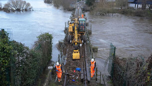<p>Irish Rail workers clear debri from the line in Enniscorthy Co Wexford after Storm Chandra. Picture: Niall Carson/PA Wire</p>
