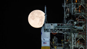 A full moon is seen behind Nasa’s space launch system at the Kennedy Space Centre in Florida (Sam Lott/Nasa via AP)