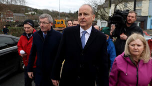 <p>Taoiseach Micheal Martin walking through Enniscorthy in County Wexford, as he meets families affected by the recent flooding. Picture: Liam McBurney/PA Wire</p>