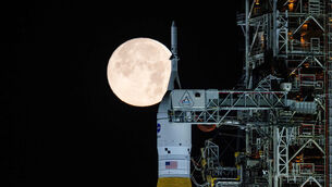 <p>A full moon is seen behind Nasa’s space launch system at the Kennedy Space Centre in Florida (Sam Lott/Nasa via AP)</p>