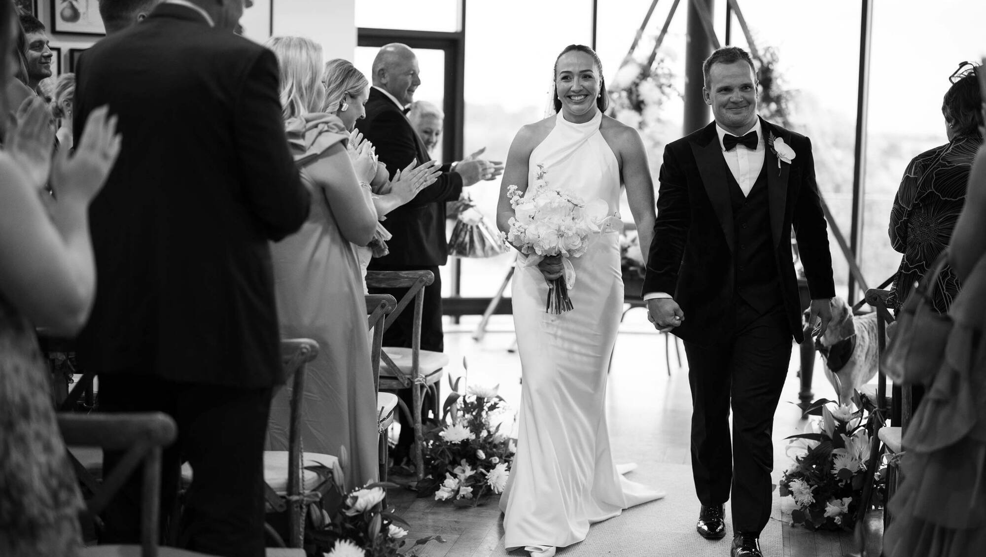 Irish rugby star Nichola Fryday and Stuart Townsend are applauded by guests after their wedding ceremony.