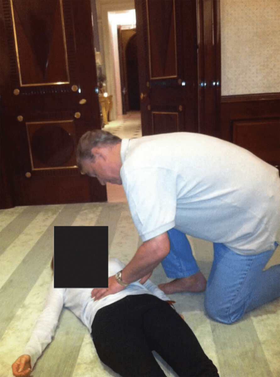 US Department of Justice photograph appearing to show Andrew Mountbatten-Windsor crouched over an unidentified woman which has been released in the latest disclosure of files linked to Jeffrey Epstein. 