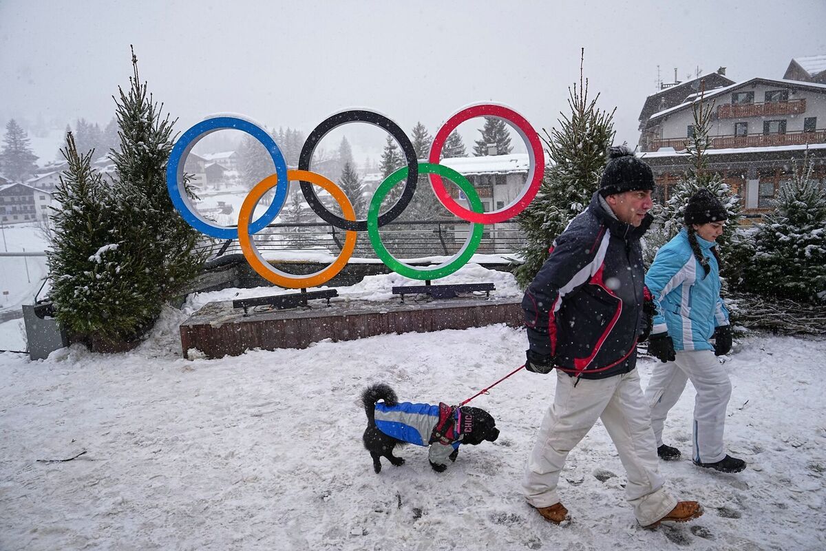 People walk past an Olympic rings installation ahead of the Olympic Winter Games Milano Cortina 2026, in Cortina d'Ampezzo. Pic: Fatima Shbair/AP