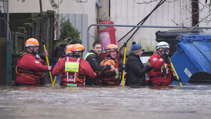 <p>People are escorted through flood waters in Enniscorthy, Co Wexford during heavy rain last week. Picture: Niall Carson/PA Wire</p>