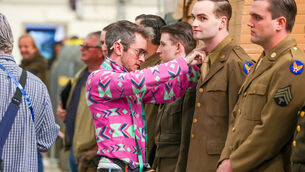 <p>Extras having their costumes checked in the “line up” before they go on set and filming starts. Picture: Neil Michael.</p>