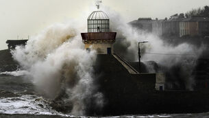 <p>Waves crash against Balbriggan lighthouse in Dublin. Picture: Brian Lawless/PA Wire</p>