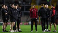 The Cork team inspects the pitch ahead of their game 7/2/2026
