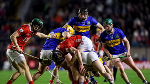 <p>Cork's Mark Coleman and Robert Downey compete for a loose ball with Conor Stakelum and Andrew Ormond of Tipperary. Mandatory Credit ©INPHO/Ben Brady</p>