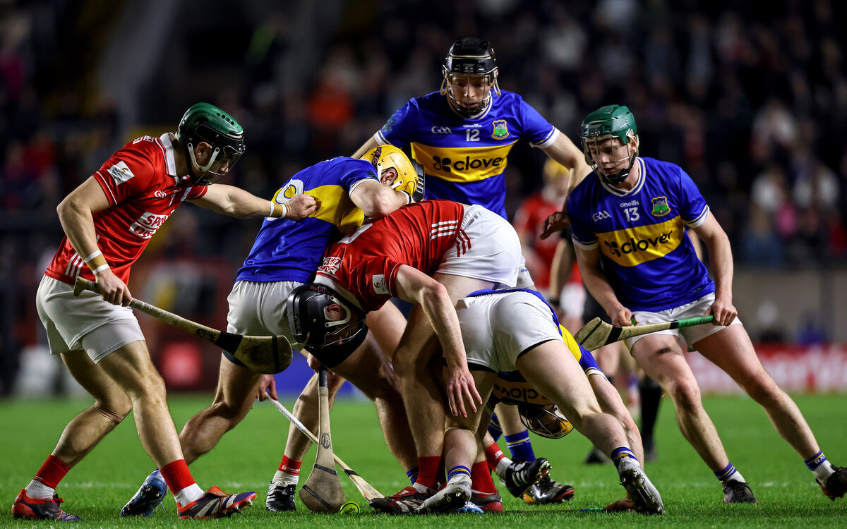 Cork's Mark Coleman and Robert Downey compete for a loose ball with Conor Stakelum and Andrew Ormond of Tipperary. Mandatory Credit ©INPHO/Ben Brady