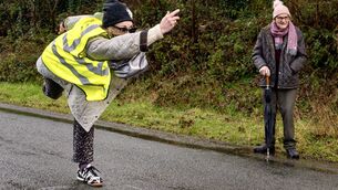<p>Organiser Eileen Gobnait Ní Lionáird in action during the all-Gobnait road bowling event in Ballyvourney as part of Féile Ghobnatan 2026. Picture: Chani Anderson</p>