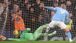 <p>SPOT ON: Alisson fails to make a save as Erling Haaland scores from a penalty. Pic: Carl Recine/Getty Images.</p>