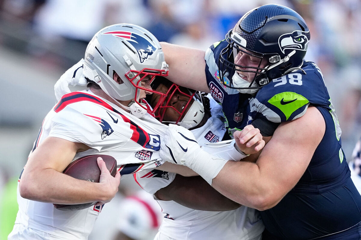 Seattle Seahawks defensive end Rylie Mills, right, sacks New England Patriots quarterback Drake Maye during the first half of the NFL Super Bowl 60 football game, Sunday, Feb. 8, 2026, in Santa Clara, Calif. (AP Photo/Julio Cortez)