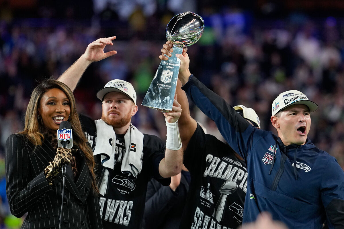 Seattle Seahawks head coach Mike MacDonald, right, and quarterback Sam Darnold lift the Lombardi Trophy after win over the New England Patriots in the NFL Super Bowl 60 football game, Sunday, Feb. 8, 2026, in Santa Clara, Calif. (AP Photo/Julio Cortez)