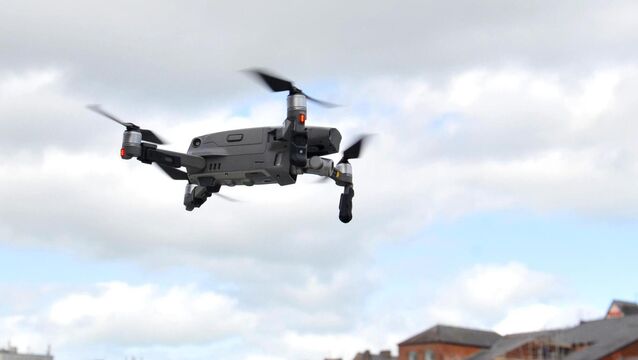 <p>A drone flying low as it returns to the landing zone under the control of the operator.</p>