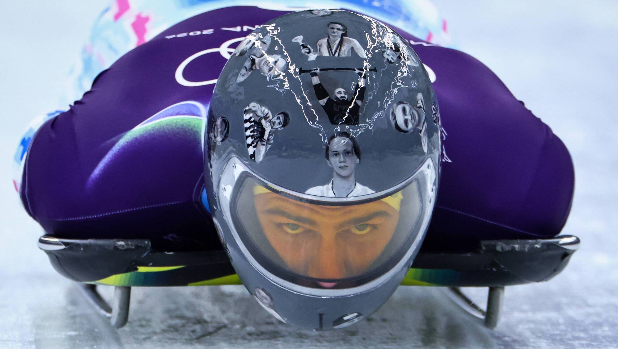 Ukrainian trains in helmet honoring fellow athletes killed in war. IOC says it’s banned for race