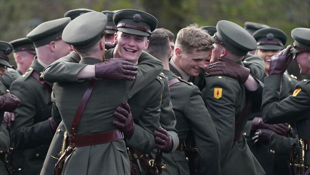 <p>Members of the Defence Forces celebrate after the commissioning ceremony of the 100th cadet class at the Defence Forces Training Centre in Curragh, Co Kildare, last March. File picture: Brian Lawless/PA </p>