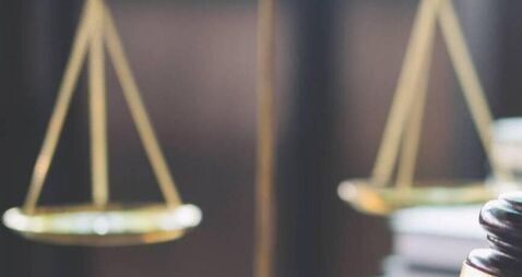 Scales of justice and Gavel on wooden table and Lawyer or Judge working with agreement in Courtroom, Justice and Law concept